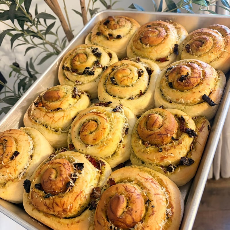 Golden cinnamon rolls arranged on a baking tray