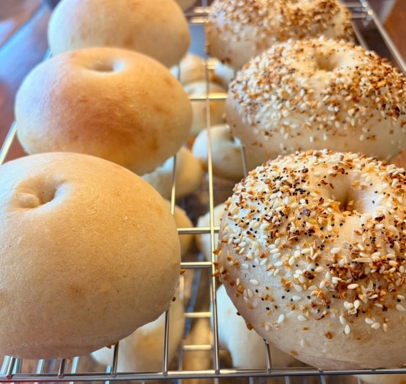 Fresh bagels cooling on a wire rack